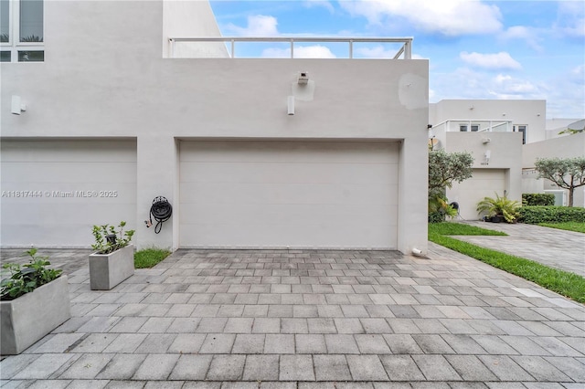 10540 NW 63rd Ter, Doral, FL 33178 - view of front of property featuring stucco siding, a garage, and decorative driveway