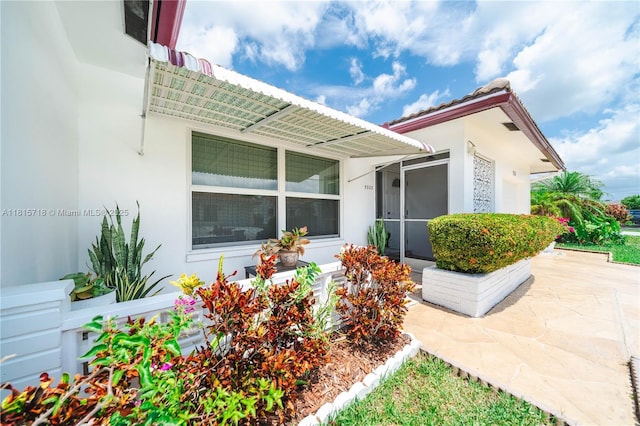 5803 NW 85th Ter, Tamarac, FL 33321 - view of side of property featuring stucco siding and a patio