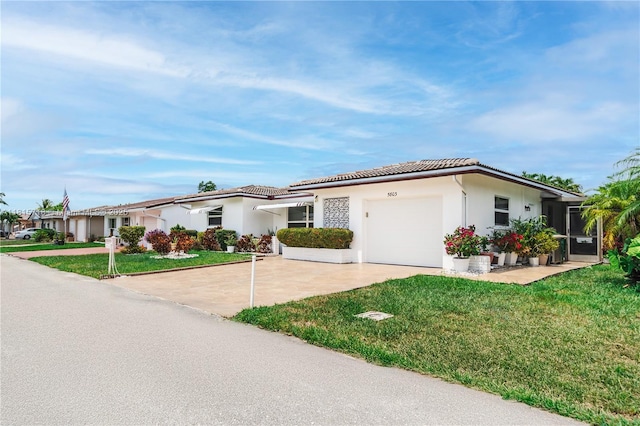 5803 NW 85th Ter, Tamarac, FL 33321 - view of front of property featuring a garage, concrete driveway, a tiled roof, and a front lawn