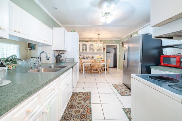 5803 NW 85th Ter, Tamarac, FL 33321 - kitchen with a sink, white appliances, washer / dryer, white cabinets, and light tile patterned floors