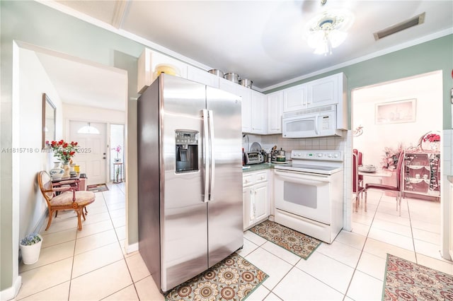 5803 NW 85th Ter, Tamarac, FL 33321 - kitchen with white appliances, tasteful backsplash, light tile patterned floors, white cabinets, and ornamental molding