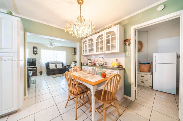 5803 NW 85th Ter, Tamarac, FL 33321 - dining room with light tile patterned floors, a chandelier, and ornamental molding