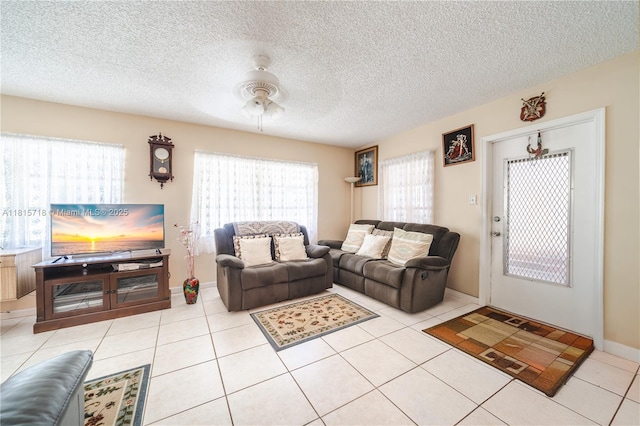 5803 NW 85th Ter, Tamarac, FL 33321 - living room with ceiling fan, light tile patterned floors, a textured ceiling, and baseboards