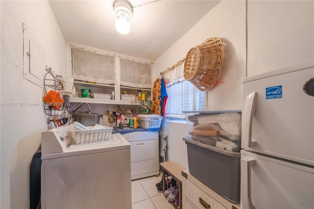 5803 NW 85th Ter, Tamarac, FL 33321 - laundry area with light tile patterned flooring and washer and clothes dryer