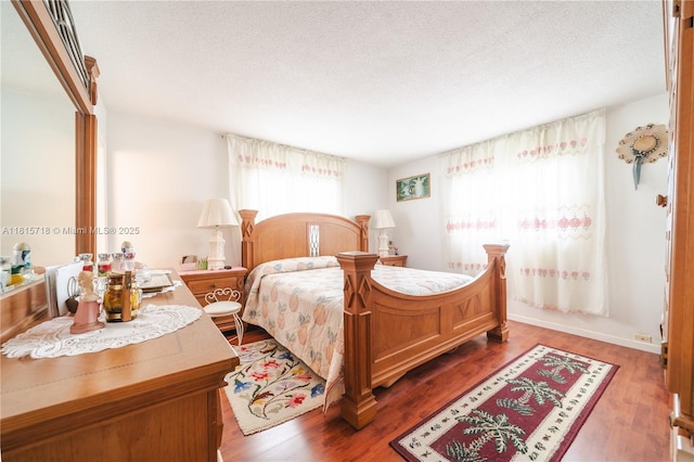 5803 NW 85th Ter, Tamarac, FL 33321 - bedroom with a textured ceiling and wood finished floors
