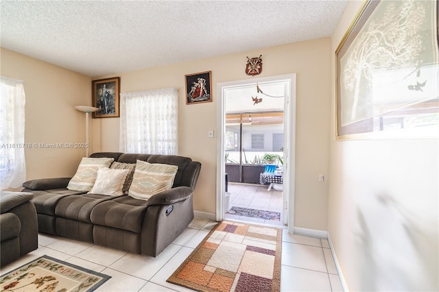 5803 NW 85th Ter, Tamarac, FL 33321 - living room featuring plenty of natural light, a textured ceiling, and light tile patterned floors