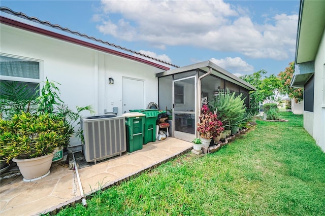 5803 NW 85th Ter, Tamarac, FL 33321 - view of grassy yard with a sunroom and cooling unit