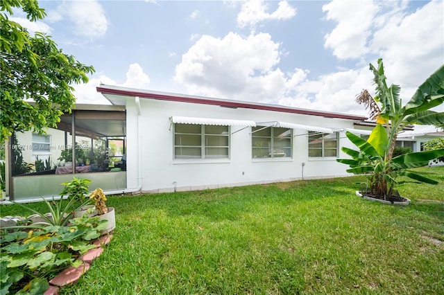 5803 NW 85th Ter, Tamarac, FL 33321 - rear view of property featuring a lawn and a sunroom