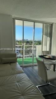 2000 NE 135th St Unit 509, North Miami, FL 33181 - bedroom featuring wood finished floors, multiple windows, and expansive windows