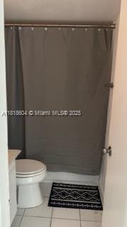2000 NE 135th St Unit 509, North Miami, FL 33181 - bathroom with tile patterned flooring, vanity, and curtained shower