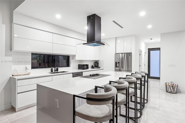 3660 SW 12th St, Miami, FL 33135 - kitchen with stainless steel fridge with ice dispenser, modern cabinets, island range hood, a sink, and a breakfast bar area