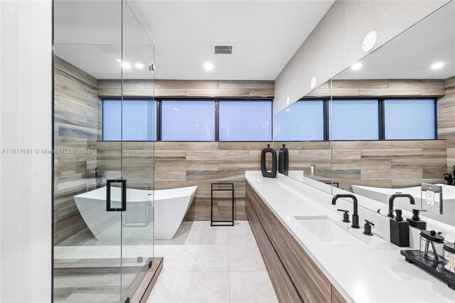 3660 SW 12th St, Miami, FL 33135 - full bath featuring double vanity, a freestanding bath, tile walls, a stall shower, and tile patterned flooring