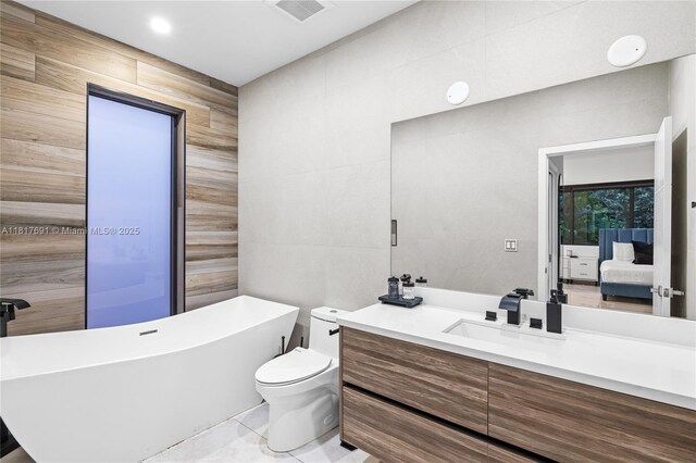 3660 SW 12th St, Miami, FL 33135 - bathroom featuring tile walls, a soaking tub, vanity, ensuite bathroom, and toilet