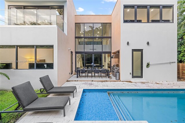 3660 SW 12th St, Miami, FL 33135 - back of house featuring stucco siding, a patio area, and an outdoor pool