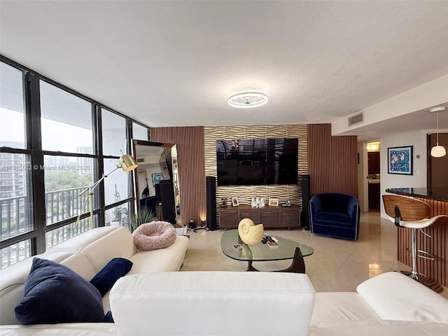 800 Parkview Dr Unit 820, Hallandale Beach, FL 33009 - living area with light tile patterned floors, a textured ceiling, and expansive windows