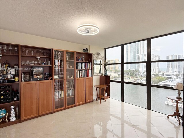 800 Parkview Dr Unit 820, Hallandale Beach, FL 33009 - bar featuring a city view, a textured ceiling, a wall of windows, and light tile patterned floors
