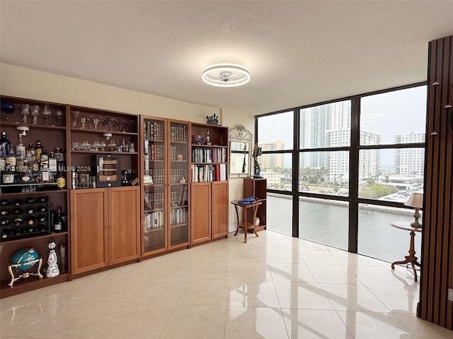 800 Parkview Dr Unit 820, Hallandale Beach, FL 33009 - bar with expansive windows, a city view, light tile patterned floors, and a textured ceiling
