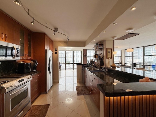 800 Parkview Dr Unit 820, Hallandale Beach, FL 33009 - kitchen featuring appliances with stainless steel finishes, light tile patterned flooring, a sink, glass insert cabinets, and brown cabinetry