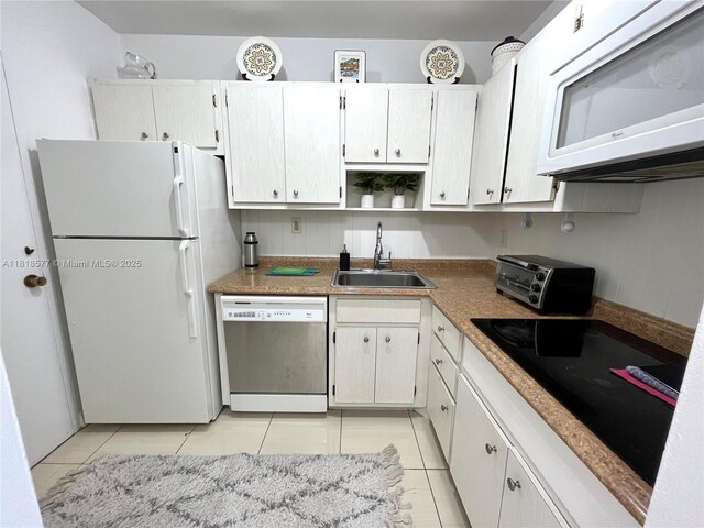 2899 Collins Ave Unit 810, Miami Beach, FL 33140 - kitchen with white appliances, a sink, light tile patterned floors, open shelves, and white cabinetry