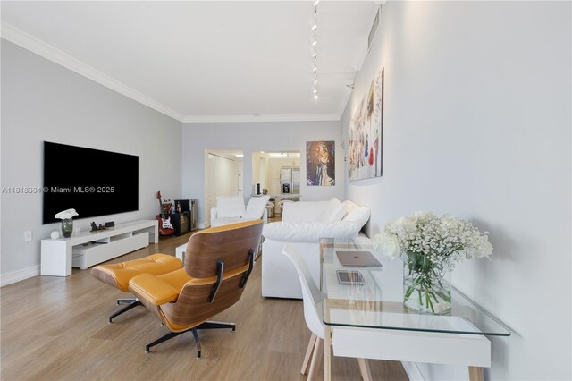 20505 E Country Club Dr Unit 143, Aventura, FL 33180 - living area featuring track lighting, crown molding, wood finished floors, and baseboards