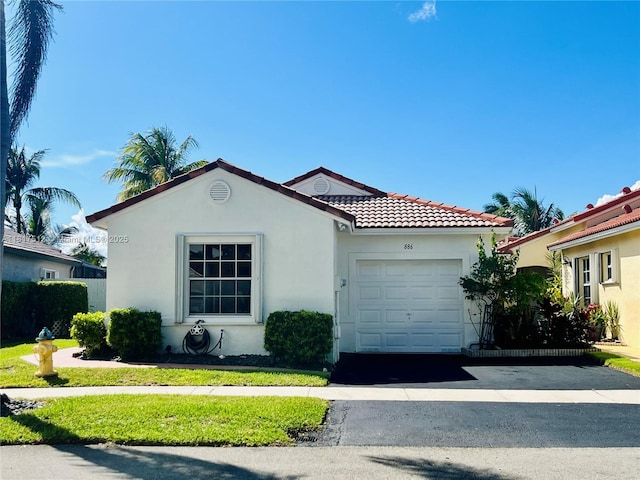 886 SW 180th Ter, Pembroke Pines, FL 33029 - mediterranean / spanish house featuring a garage, stucco siding, driveway, and a tile roof
