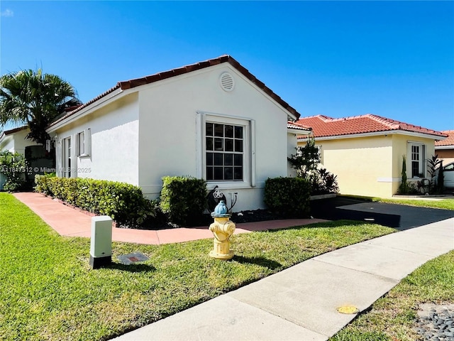 886 SW 180th Ter, Pembroke Pines, FL 33029 - view of home's exterior with a yard, stucco siding, and a tile roof