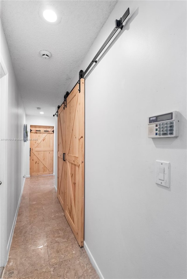 886 SW 180th Ter, Pembroke Pines, FL 33029 - hallway with a barn door and a textured ceiling