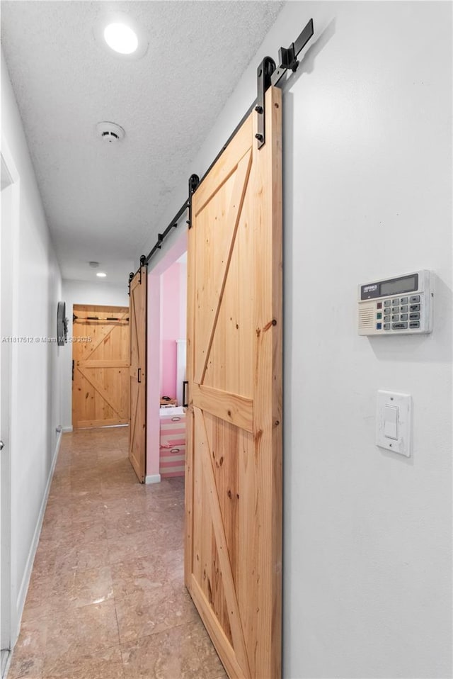 886 SW 180th Ter, Pembroke Pines, FL 33029 - hall featuring a barn door, a textured ceiling, and recessed lighting