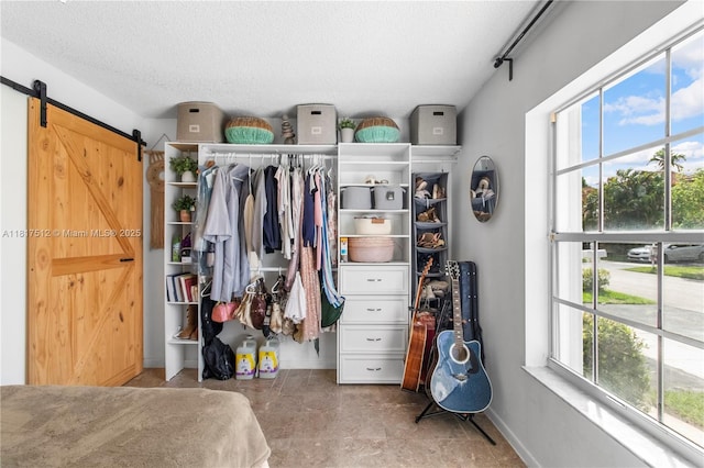 886 SW 180th Ter, Pembroke Pines, FL 33029 - bedroom with a closet, multiple windows, a textured ceiling, and a barn door