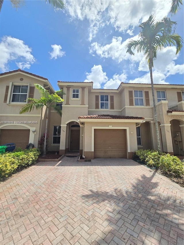 129 Riverwalk Cir Unit 129, Sunrise, FL 33326 - multi unit property with stucco siding, decorative driveway, an attached garage, and a tiled roof