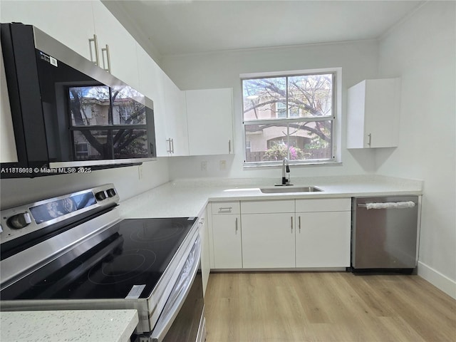 129 Riverwalk Cir Unit 129, Sunrise, FL 33326 - kitchen with stainless steel appliances, a sink, light wood-style floors, and white cabinets