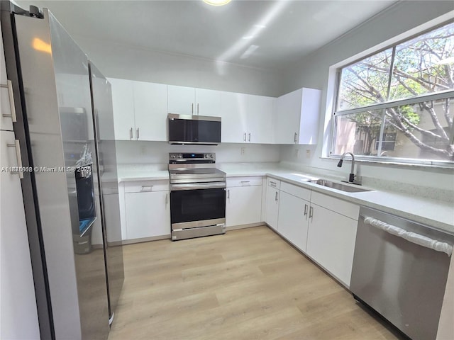129 Riverwalk Cir Unit 129, Sunrise, FL 33326 - kitchen with stainless steel appliances, a sink, light countertops, and light wood finished floors