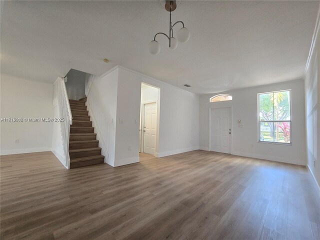 129 Riverwalk Cir Unit 129, Sunrise, FL 33326 - unfurnished living room with stairway, wood finished floors, a chandelier, and baseboards