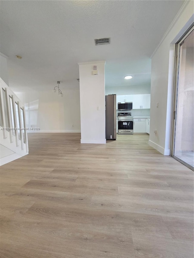 129 Riverwalk Cir Unit 129, Sunrise, FL 33326 - unfurnished living room with baseboards, stairs, light wood-type flooring, and crown molding