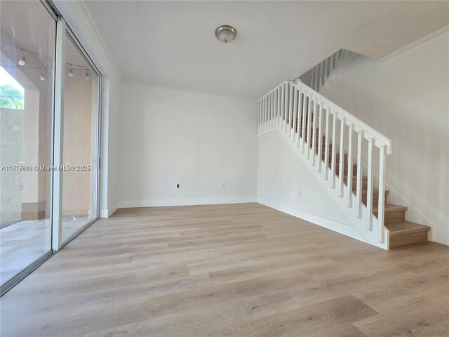 129 Riverwalk Cir Unit 129, Sunrise, FL 33326 - unfurnished living room featuring light wood-style floors, stairway, and baseboards