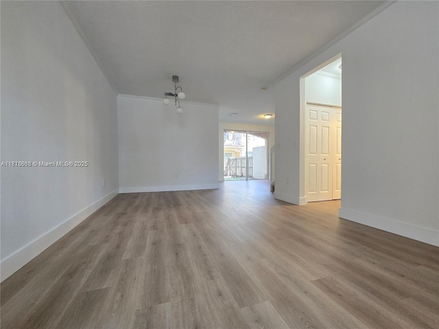 129 Riverwalk Cir Unit 129, Sunrise, FL 33326 - spare room featuring light wood-style flooring, ornamental molding, and baseboards