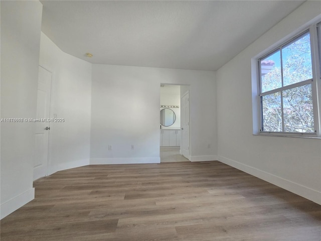 129 Riverwalk Cir Unit 129, Sunrise, FL 33326 - spare room featuring baseboards and wood finished floors