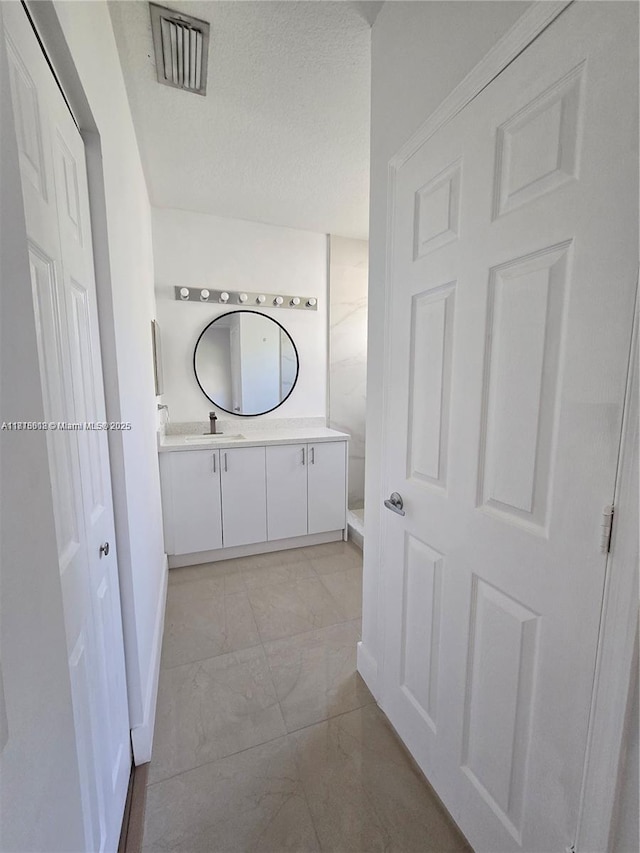 129 Riverwalk Cir Unit 129, Sunrise, FL 33326 - full bathroom featuring vanity, marble look tile flooring, a textured ceiling, and baseboards