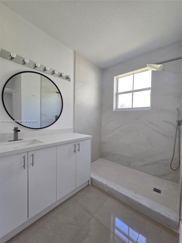 129 Riverwalk Cir Unit 129, Sunrise, FL 33326 - full bath with vanity, marble look tiles, a marble finish shower, and a textured ceiling