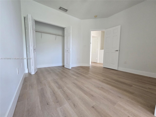 129 Riverwalk Cir Unit 129, Sunrise, FL 33326 - unfurnished bedroom featuring light wood finished floors, a closet, and baseboards