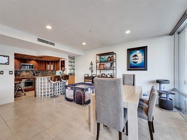1408 Brickell Bay Dr Unit 411, Miami, FL 33131 - dining room with light tile patterned flooring and recessed lighting