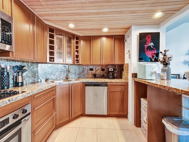 1408 Brickell Bay Dr Unit 411, Miami, FL 33131 - kitchen with appliances with stainless steel finishes, wood ceiling, light tile patterned flooring, light stone counters, and tasteful backsplash