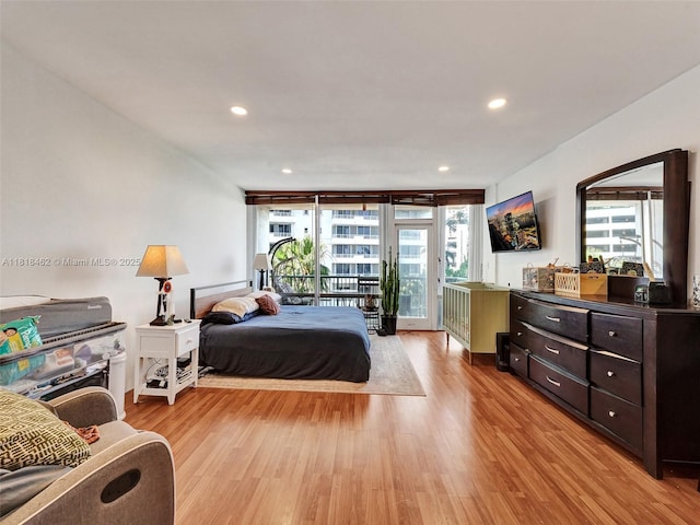 1408 Brickell Bay Dr Unit 411, Miami, FL 33131 - bedroom with access to outside, multiple windows, light wood-style floors, recessed lighting, and a wall of windows