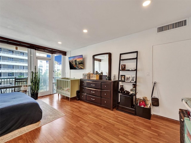 1408 Brickell Bay Dr Unit 411, Miami, FL 33131 - bedroom with access to exterior, light wood-type flooring, a wall of windows, and recessed lighting