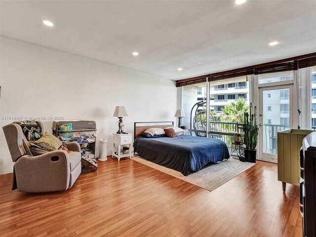 1408 Brickell Bay Dr Unit 411, Miami, FL 33131 - bedroom featuring access to outside, wood finished floors, expansive windows, and recessed lighting