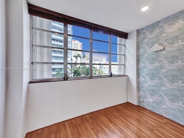 1408 Brickell Bay Dr Unit 411, Miami, FL 33131 - spare room featuring wood finished floors, recessed lighting, and a view of city