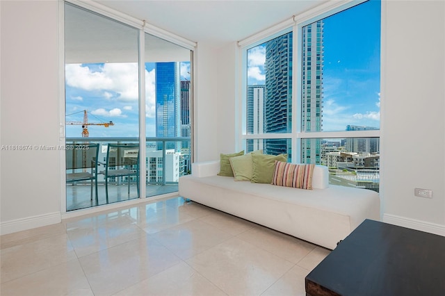 480 NE 30th St Unit 1505, Miami, FL 33137 - living area featuring expansive windows, plenty of natural light, tile patterned flooring, and a view of city