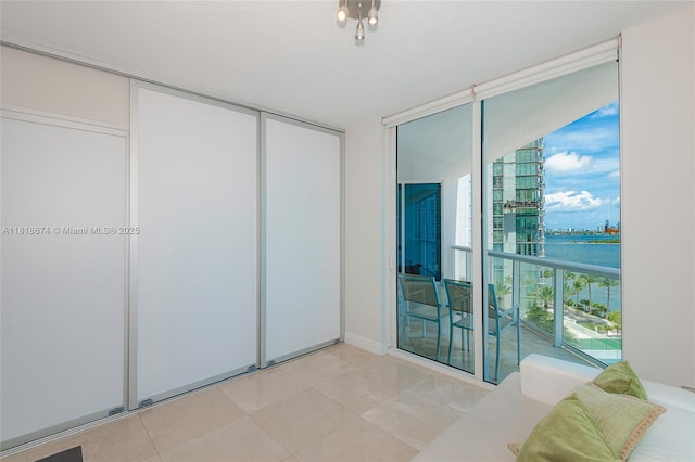 480 NE 30th St Unit 1505, Miami, FL 33137 - bedroom featuring floor to ceiling windows, a closet, and light tile patterned floors
