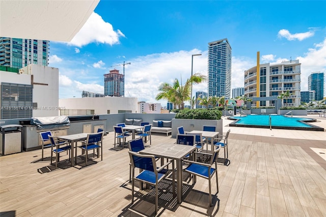480 NE 30th St Unit 1505, Miami, FL 33137 - wooden terrace with outdoor dining area, a city view, a community pool, and a grill