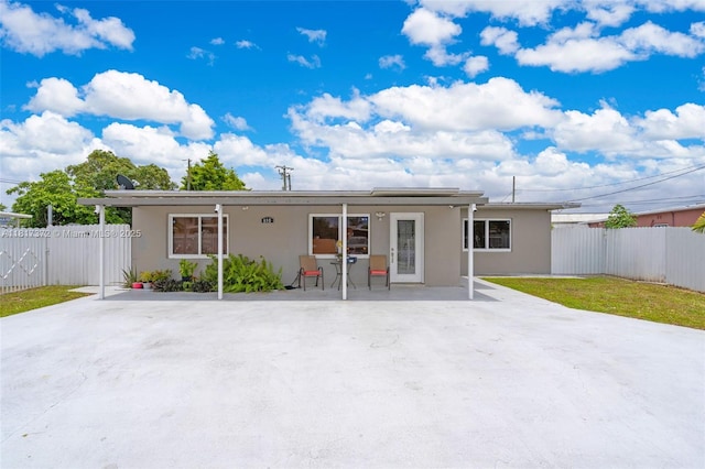 810 E 9th Pl, Hialeah, FL 33010 - rear view of house with stucco siding and a patio area